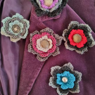 Crochet flower brooch with metal button